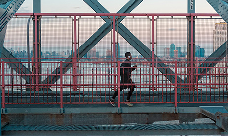 Man jogging across the bridge