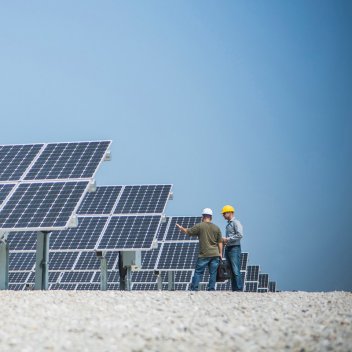 two Engineers inspecting solar panels
