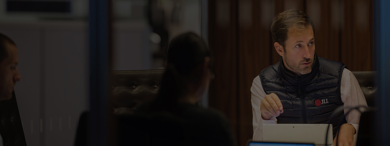 Employees discussing a strategy inside JLL office building